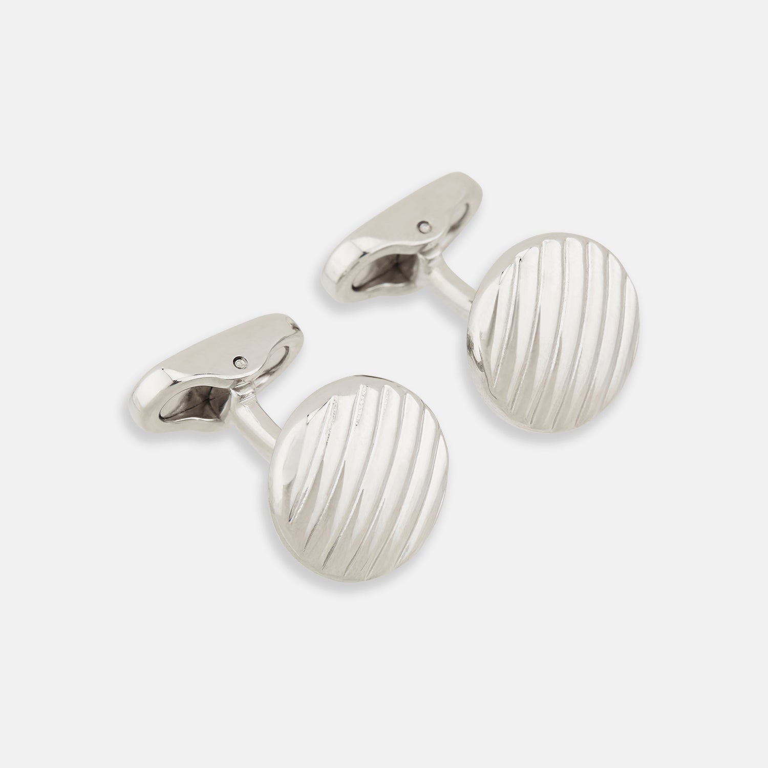 View 1 of product Turnbull & Asser’s Silver Striped Circle Cufflinks feature classic diagonal grooves and are shown against a white background.