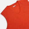 View 2 of product The Turnbull & Asser Red Orange Cashmere Sleeveless Vest with a V-neck, ribbed hem, and minimalist design is showcased against a white background—ideal for the refined gentleman.