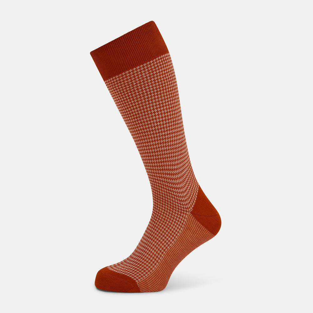 The Rose Houndstooth Mid-Length Sock by Turnbull & Asser, shown in red and white with solid red toe, heel, and cuff, is displayed on a plain white background.