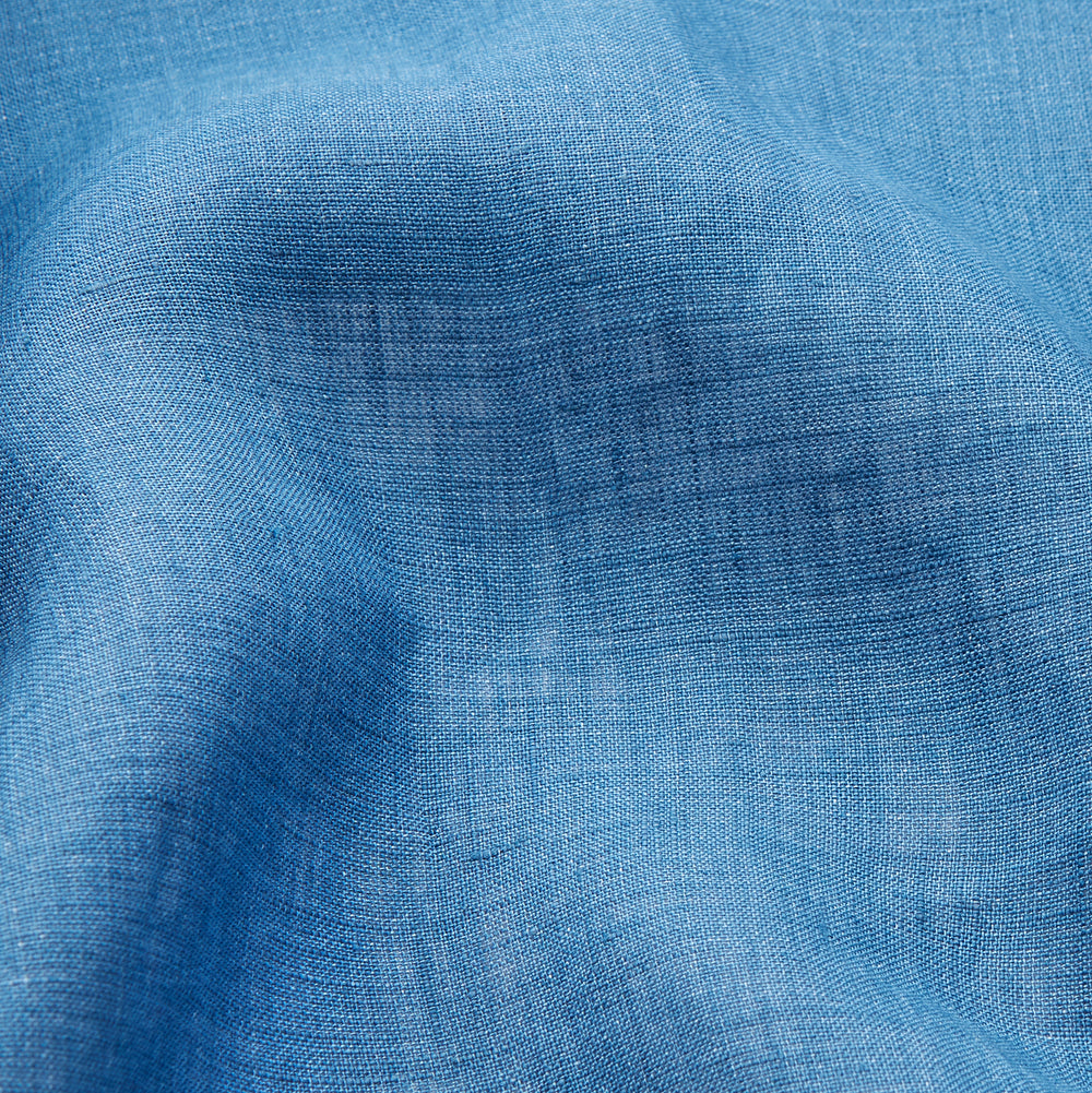 A person stands barefoot against a plain background, wearing the Teal Linen Modern Pyjama Set from Turnbull & Asser.