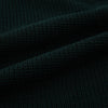 View 6 of product The Forest Green Greenwich Knitted Overshirt by Turnbull & Asser, crafted from Italian wool, features long sleeves, a collar, front buttons, and two chest pockets—one flap, one open—shown on a white background.