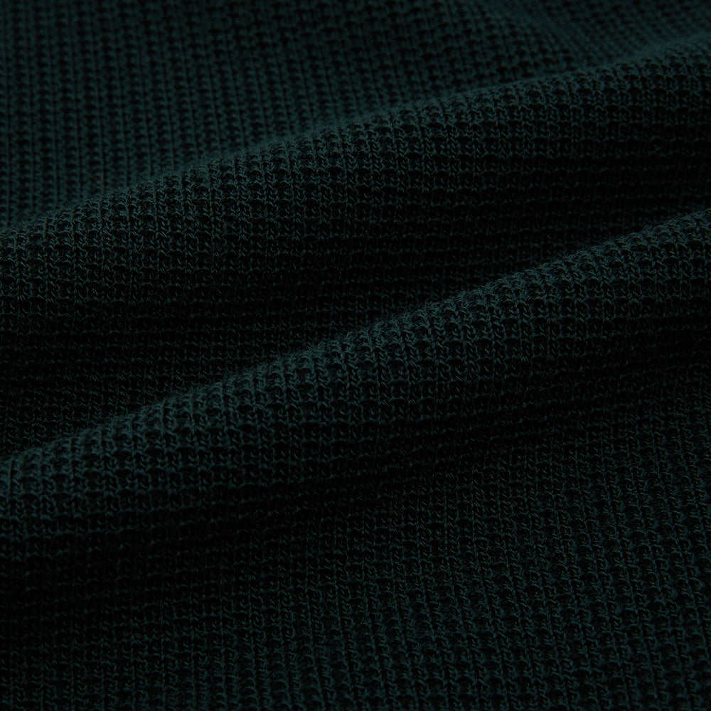 The Forest Green Greenwich Knitted Overshirt by Turnbull & Asser, crafted from Italian wool, features long sleeves, a collar, front buttons, and two chest pockets—one flap, one open—shown on a white background.