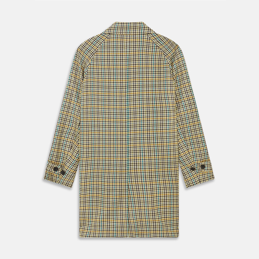 The Turnbull & Asser Green and Blue Multi Check Wool Elliot Coat is a men’s knee-length, long-sleeved overcoat with a collar and button-up front, crafted from Scottish wool in a check plaid pattern, shown on a white background.
