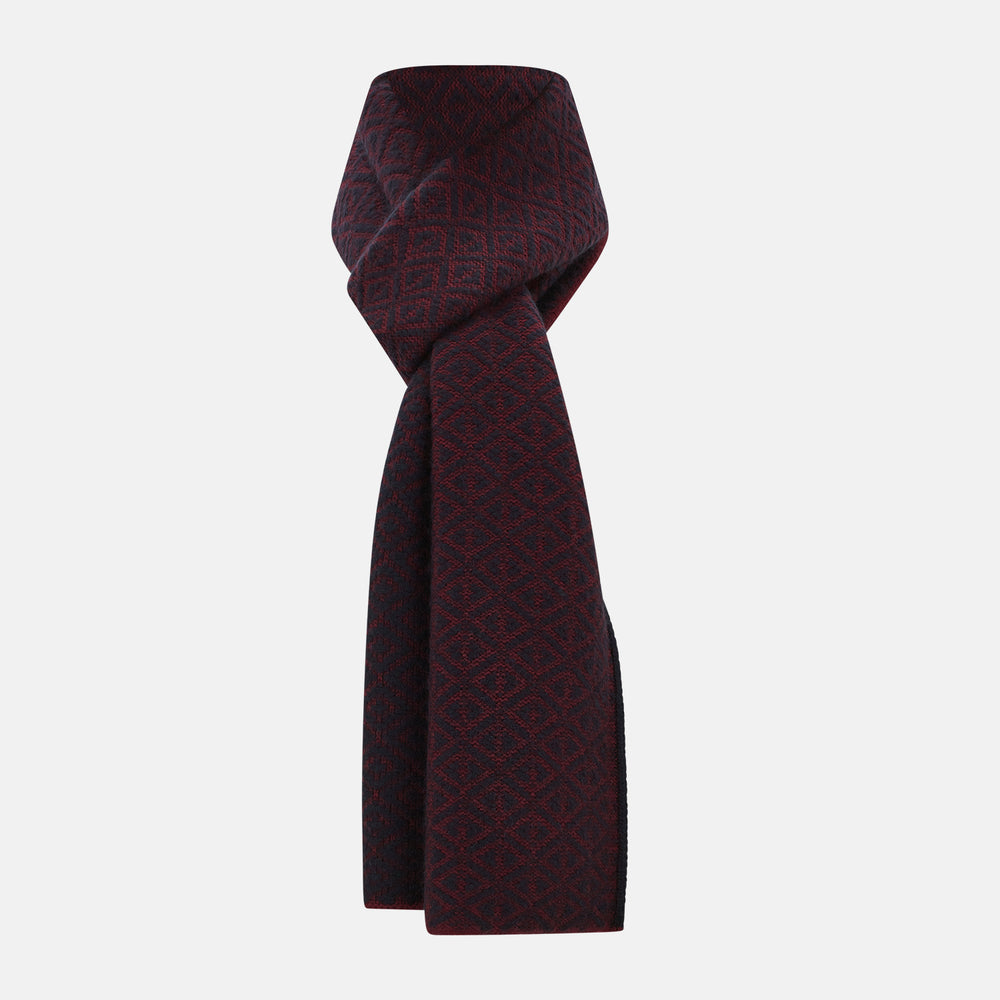 The Turnbull & Asser Navy and Burgundy Diamond-Patterned Cashmere Knitted Scarf, displayed upright on a plain white background, exudes sumptuous softness.