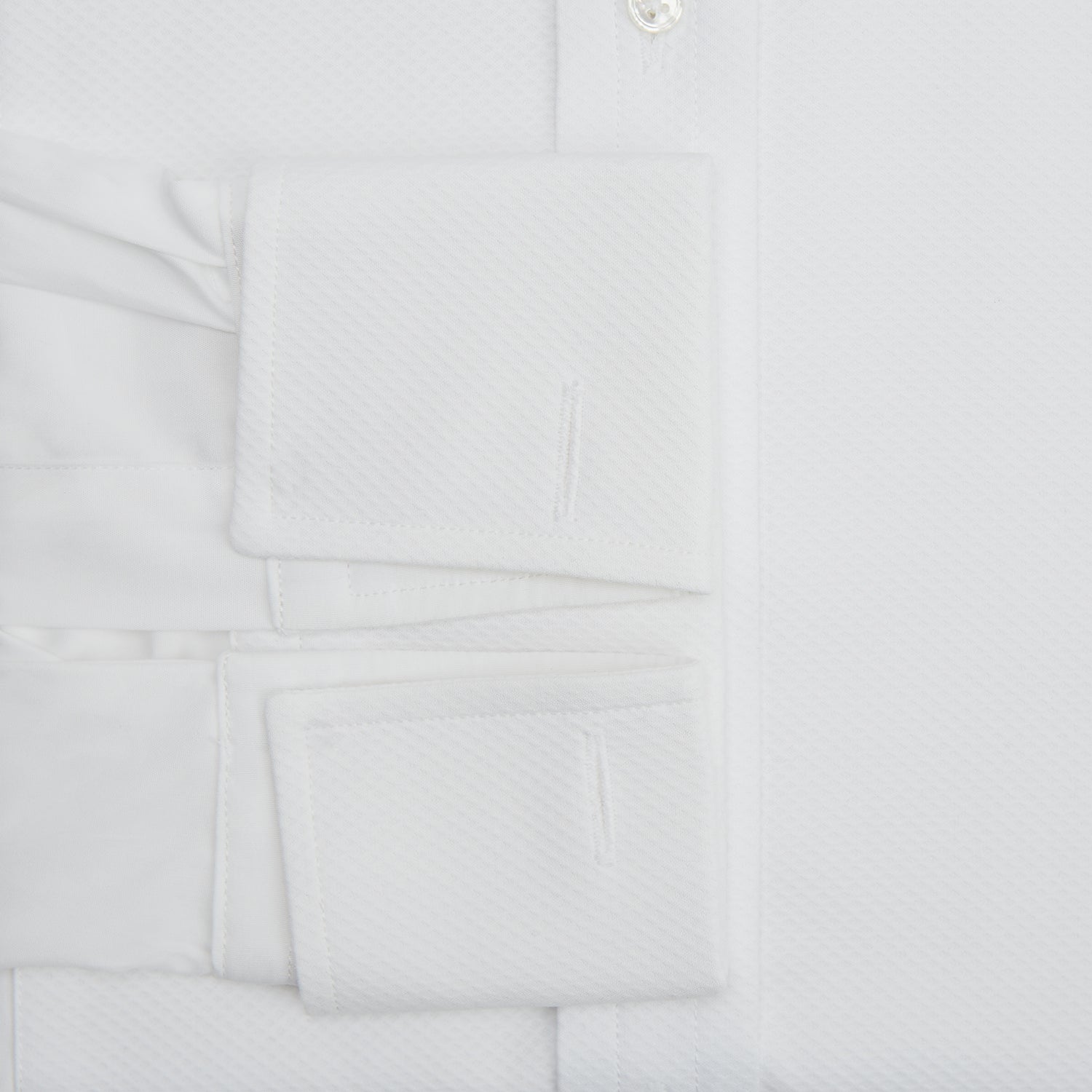 View 4 of product The Turnbull & Asser White Marcella Dress Shirt features a T&A collar, double cuffs, and pleated front detailing—ideal for formal occasions. Displayed on a plain white background.