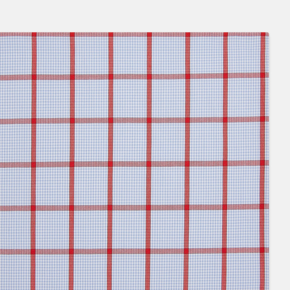 The Turnbull & Asser Hand Rolled Red Windowpane Check Handkerchief features a light blue and white gingham base with red checks—perfect as a gentleman's pocket square for a refined, classic touch.