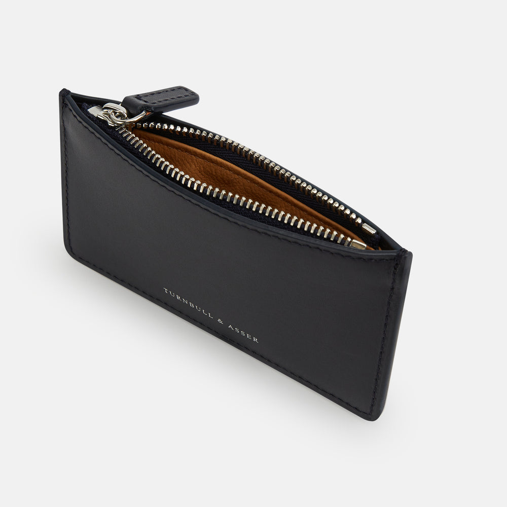 A navy leather zip wallet with Turnbull & Asser printed in small white letters on the front, set against a plain white background.