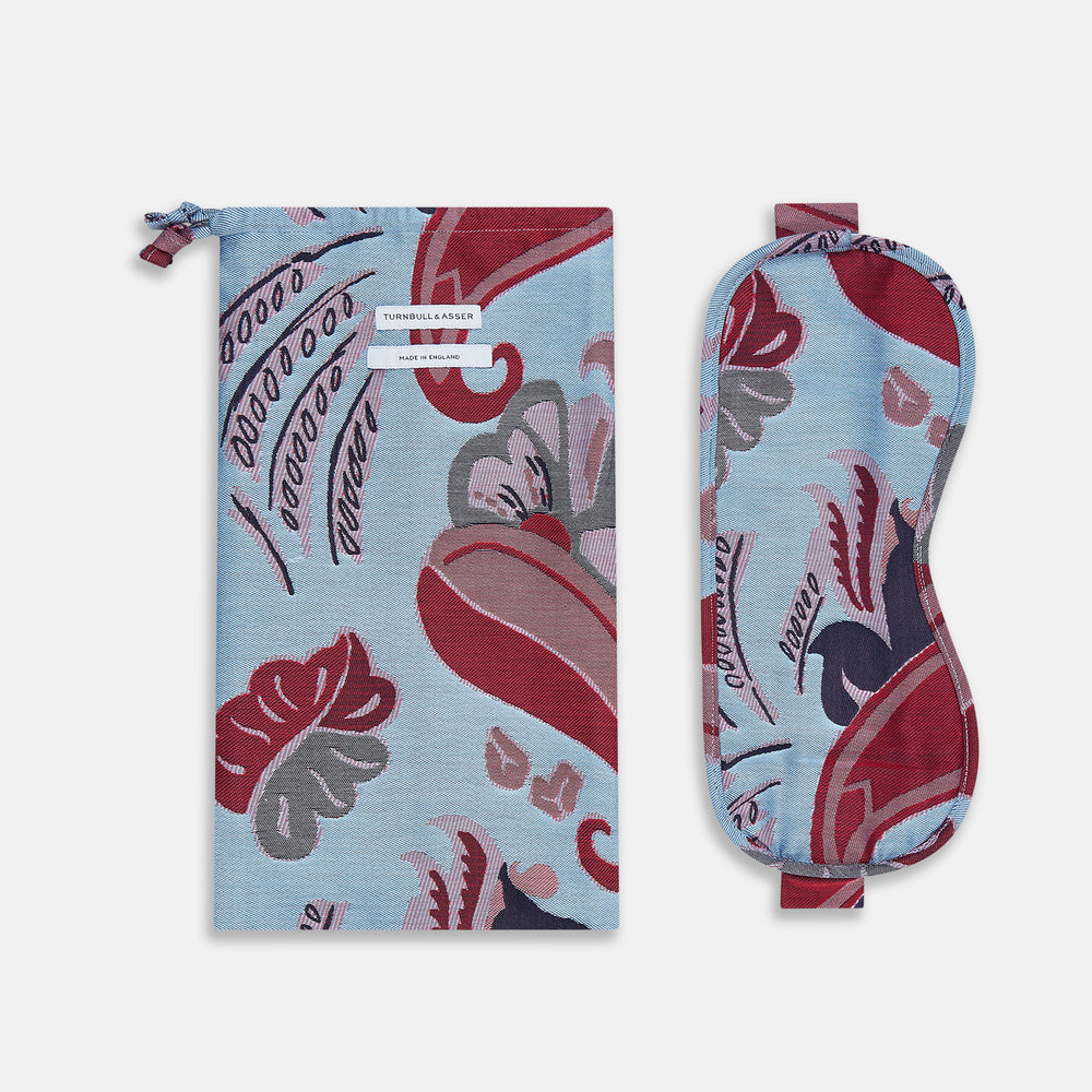 The Blue Bloomsbury Jacquard Cashmere Lined Sleep Mask and Bag by Turnbull & Asser features a blue and red abstract floral pattern, elastic strap, and is shown on a plain white background.