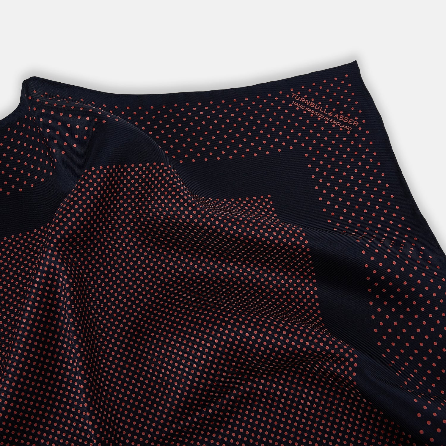 View 2 of product The Turnbull & Asser Navy and Orange Dot Silk Pocket Square features exquisite handmade craftsmanship.