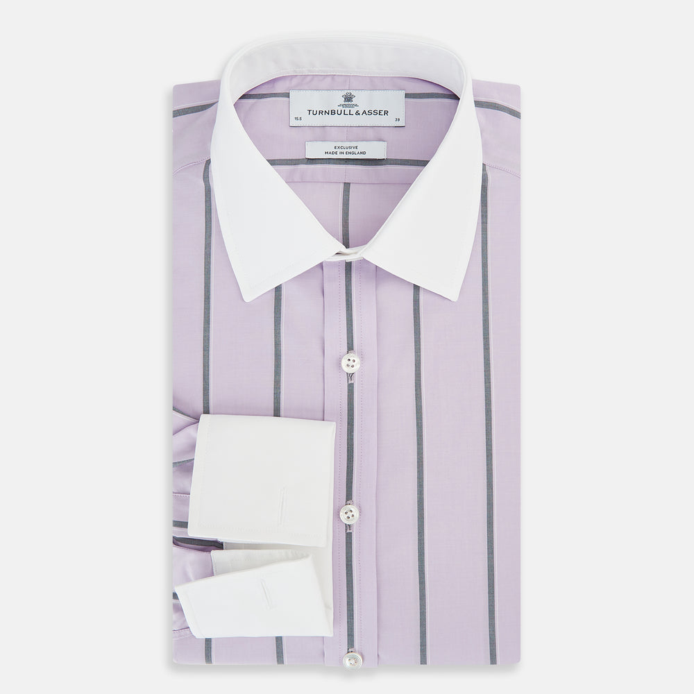 The Turnbull & Asser Lilac Track Stripe Shirt with Contrast T&A Collar and Cuffs features vertical black stripes, a white pointed collar, and white cuffs, shown flat against a white background.
