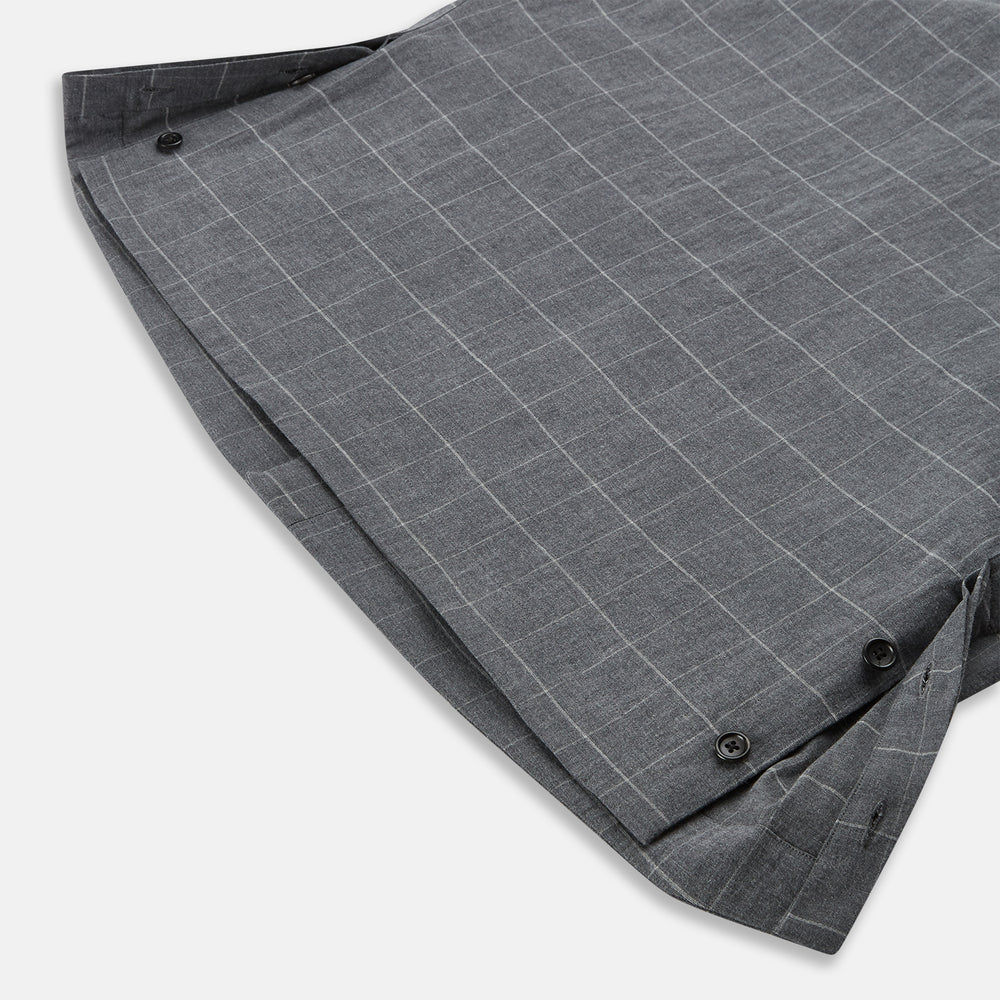 The Turnbull & Asser Charcoal Melange Check Hampstead overshirt, a long-sleeve button-up with a collar and two zippered side pockets, is laid flat on a light gray background.