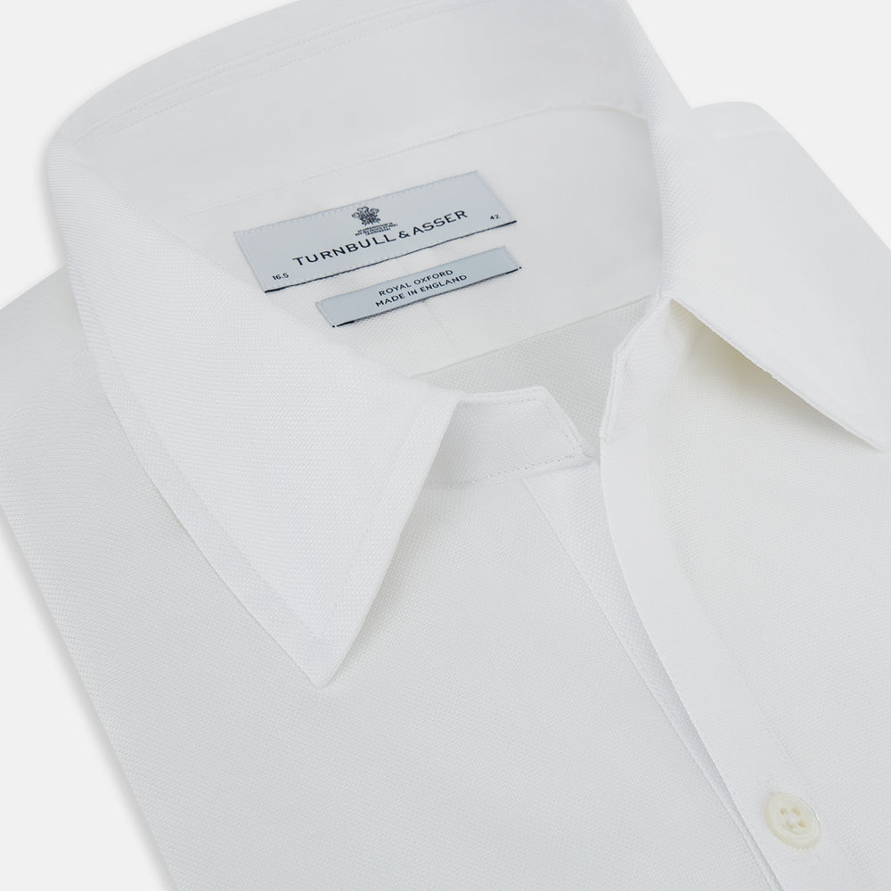 The Turnbull & Asser White Royal Oxford Cotton Windsor Shirt features a Turnbull open collar, long sleeves, 3-button cuffs, and a straight hem, shown against a plain white background.