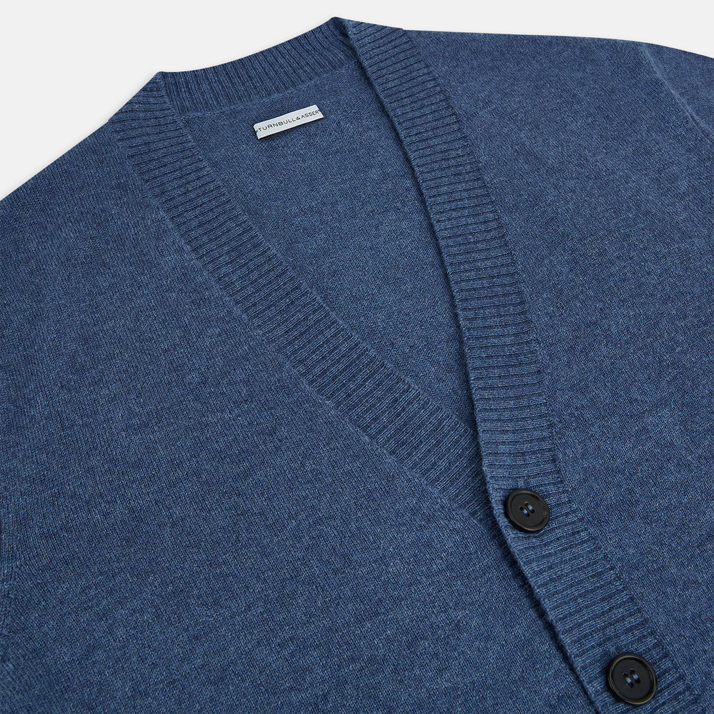 Turnbull & Asser Blue Cashmere Cardigan in soft knit, with black buttons, ribbed cuffs and hem, and two front pockets in vibrant colours—shown on a plain white background.