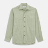 View 2 of product Close-up of Turnbull & Asser's Green Check Cotton Fabric with intersecting green and white lines and squares, displayed within a circular frame against a light gray background.