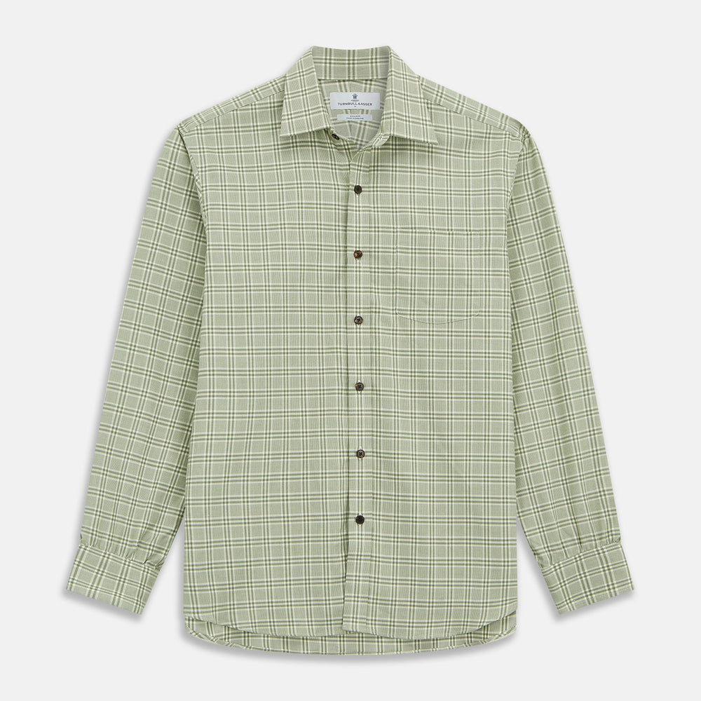 Close-up of Turnbull & Asser's Green Check Cotton Fabric with intersecting green and white lines and squares, displayed within a circular frame against a light gray background.
