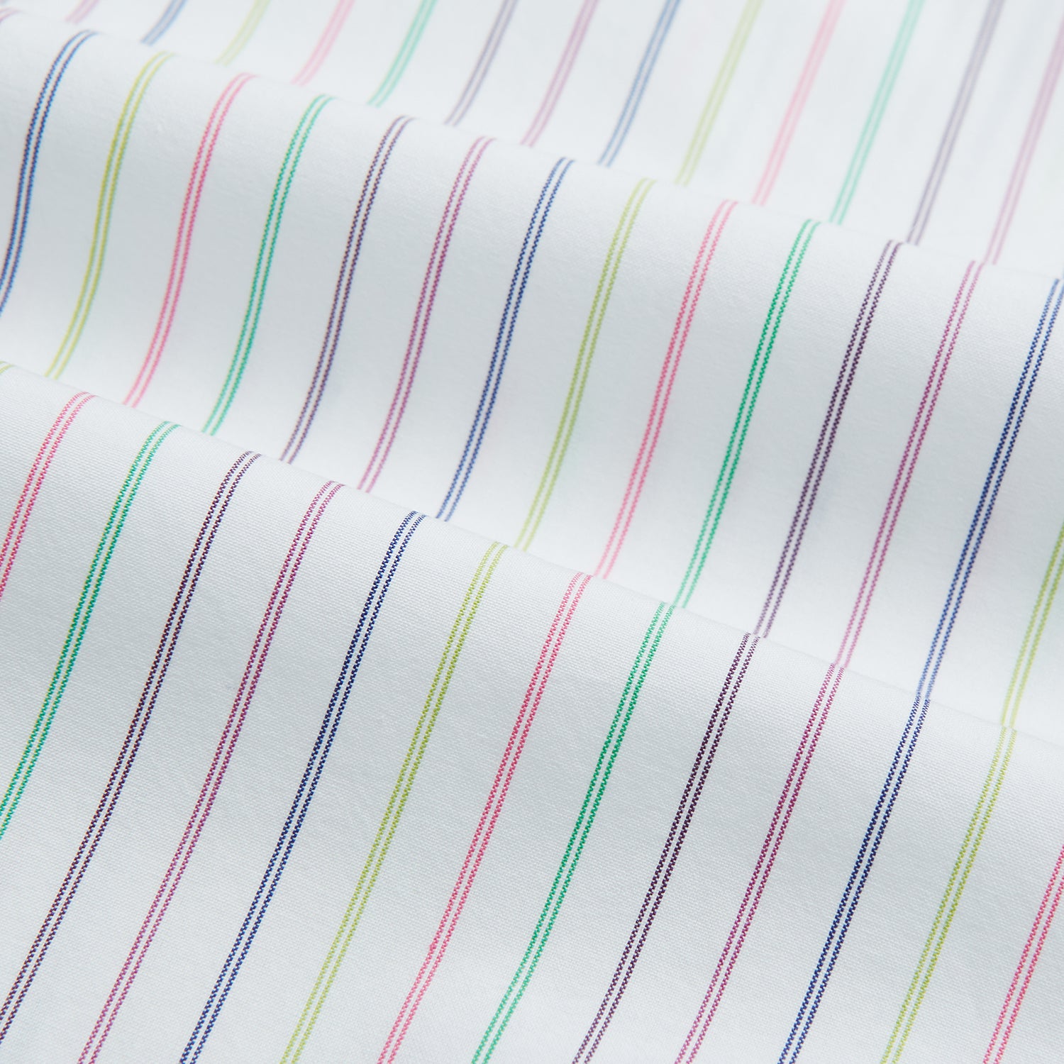 View 13 of product The Turnbull & Asser Multicoloured Double Pinstripe Mayfair Shirt, made from organic cotton, features thin blue, green, and pink stripes on white and is displayed laid flat on a white surface.