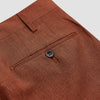 View 2 of product Turnbull & Asser’s Rust Linen-Wool-Silk Gerry Trousers, in a classic fit with straight legs, pleats, belt loops, and front button-zip closure, are neatly displayed flat on a white background.