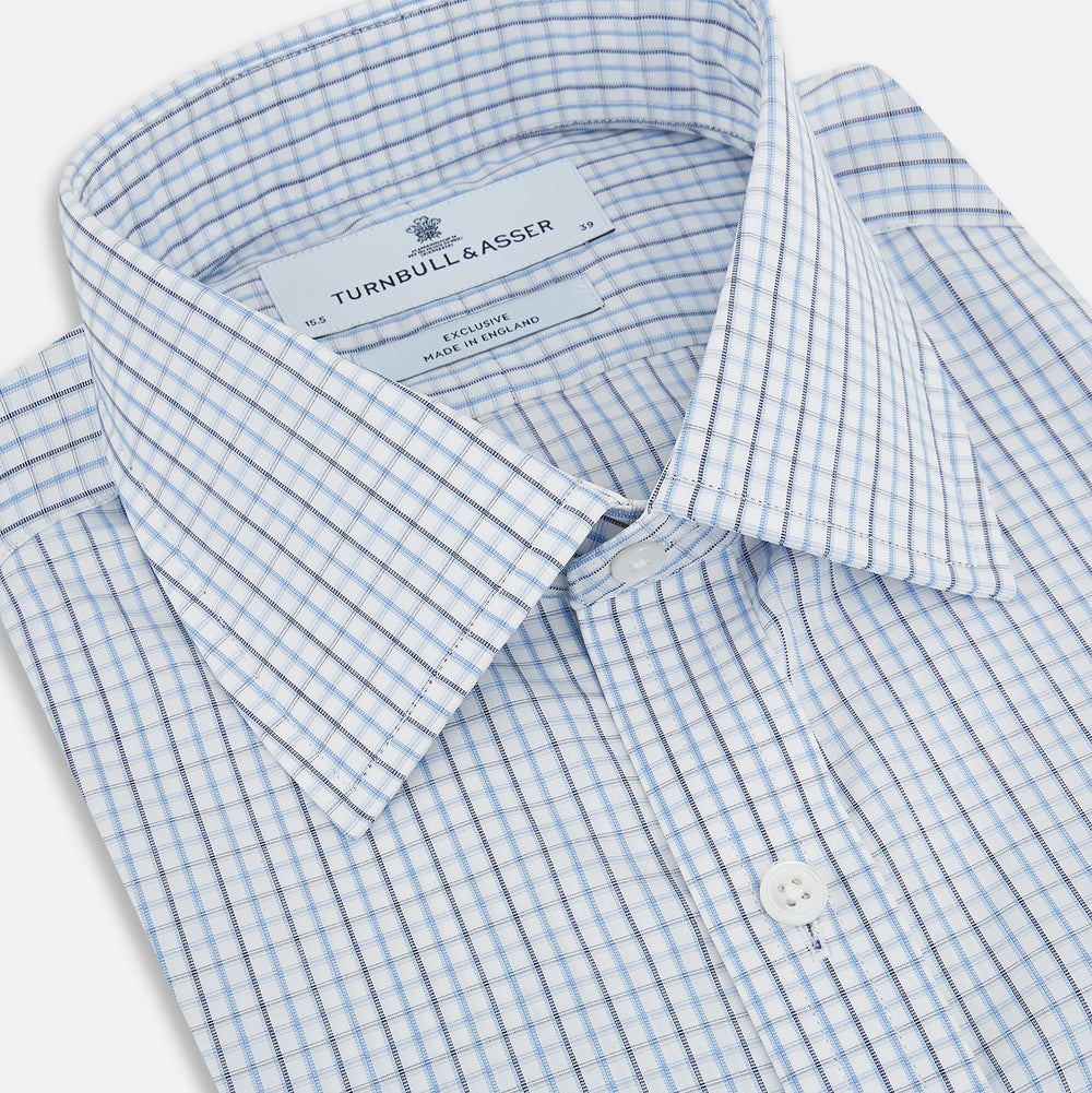 The Turnbull & Asser Navy and Blue Multi Check Mayfair Shirt features a T&A collar, button cuffs, and a blue checkered pattern. This long-sleeve, button-up shirt is shown on a white background.