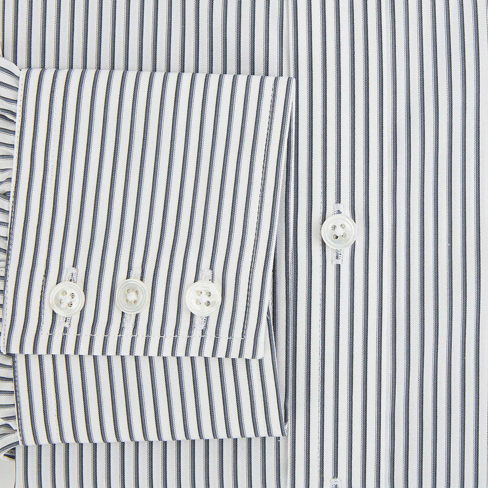 The Turnbull & Asser Grey Multi Stripe Mayfair Shirt features long sleeves, a classic collar, and thin vertical stripes in black and white, shown laid flat on a white background.