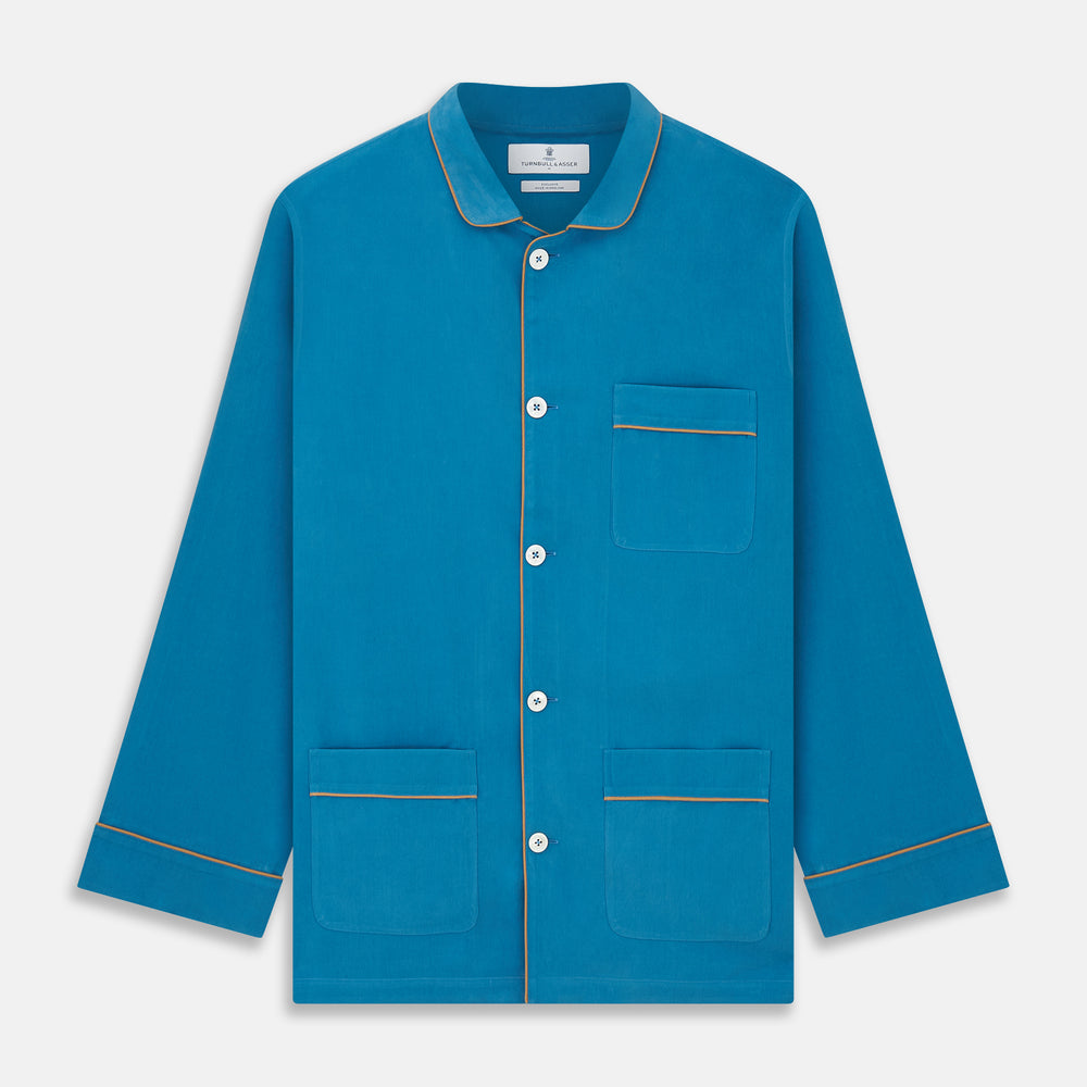 The Turnbull & Asser Blue Silk Hyde Pyjama Set features a modern fit with a long-sleeve button-up top, three pockets, white trim, and elastic-waist pants, all shown on a white background.
