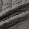 View 4 of product The Shadow Grey Quilted Gilet by Turnbull & Asser is a sleeveless, lightweight layer featuring a front zipper, two zippered side pockets, one chest pocket, and a rounded hem—shown on a plain white background.