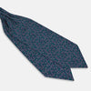 View 3 of product Turnbull & Asser's Multicoloured Dark Navy Circle Silk Cravat features blue, white, and green-outlined circles—ideal for weddings or pairing with classic British attire.