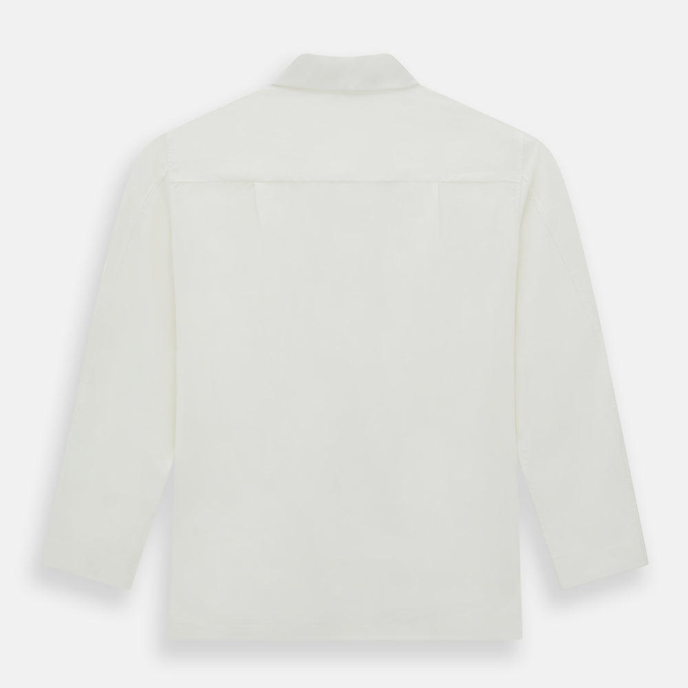 The Turnbull & Asser Cream Silk Pyjama Set, shown laid flat on a white background, features a long-sleeve button-up top with a chest pocket and matching pants with an elastic drawstring waist—ideal for comfortable loungewear.