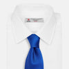 View 2 of product The Turnbull & Asser SATIN CRUISE TIE, in vibrant royal blue with a smooth, lustrous finish, creates a striking contrast against a plain white background.