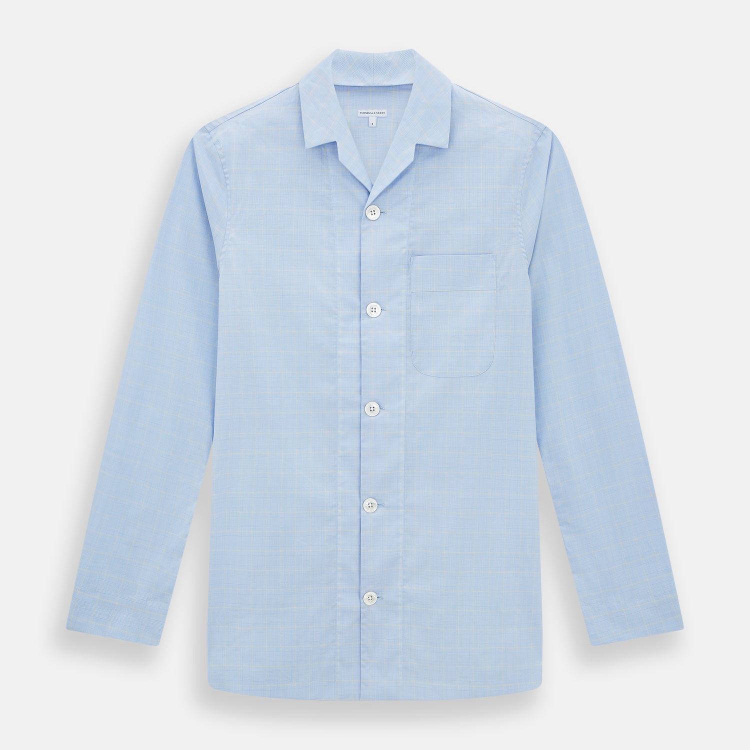 View 1 of product The Turnbull & Asser Blue Prince of Wales Check Pyjama Shirt features long sleeves, a notched collar, a left chest pocket, and a subtle check pattern, shown laid flat on a white background.