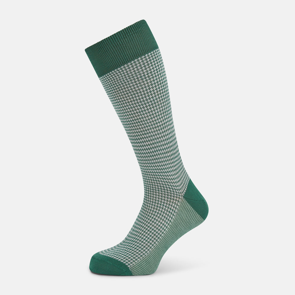 The Turnbull & Asser Ivory Houndstooth Mid-Length Sock features a green and white houndstooth pattern with solid green cuff, heel, and toe accents. Displayed on a plain white background.