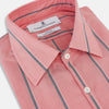 View 2 of product The Coral Pink Track Stripe Westminster Shirt by Turnbull & Asser features vertical navy and white stripes, a tailored fit, pointed collar, and buttoned cuffs—is displayed laid flat on a white background.