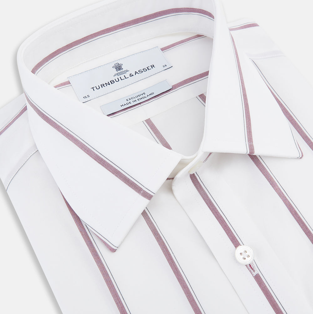 The Turnbull & Asser Wine Track Stripe Mayfair Shirt is a white long-sleeve shirt with vertical wine stripes and a pointed collar, crafted from premium Italian cotton and shown flat against a plain background.