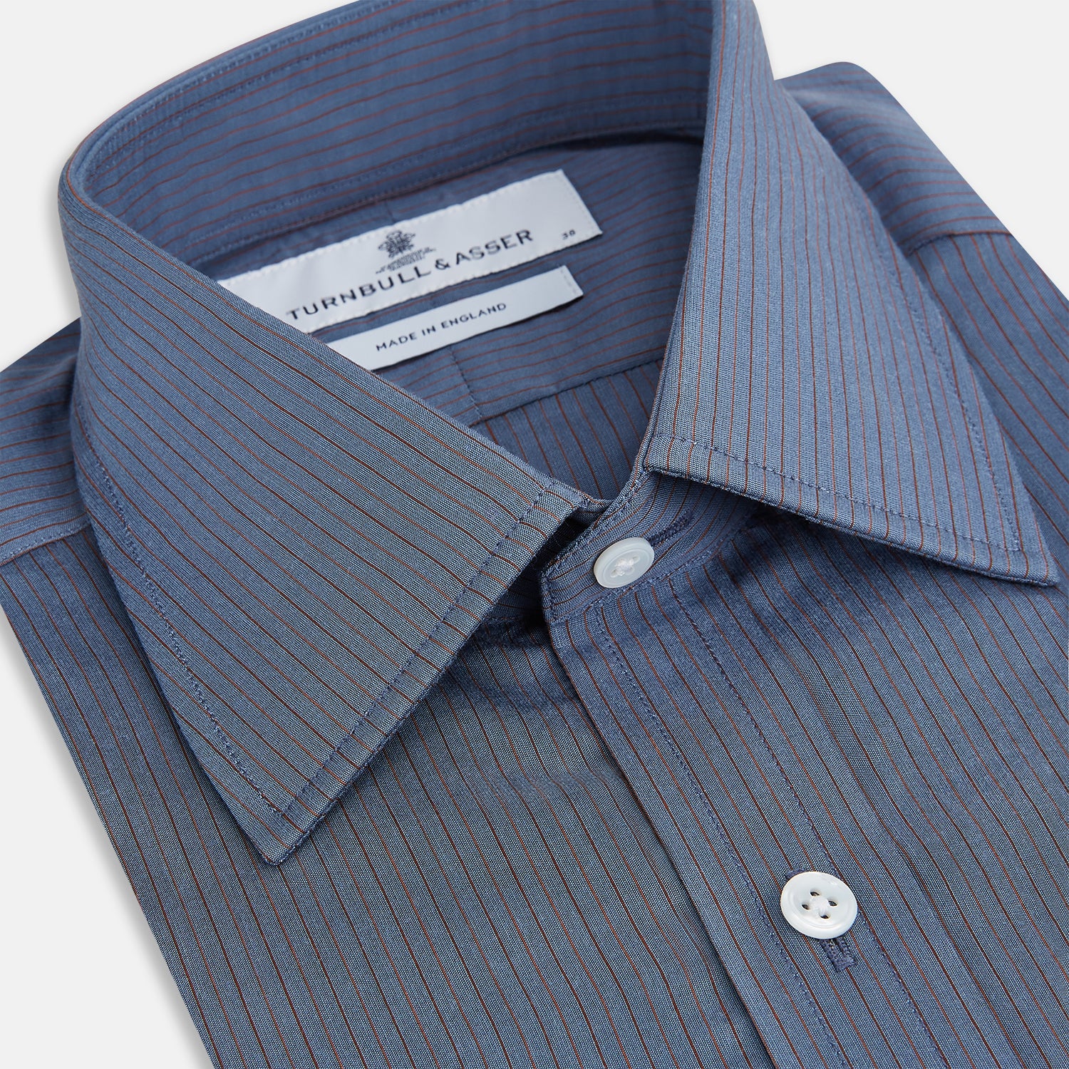 View 2 of product A neatly folded men's Mid Blue Red Stripe Regular Fit Mayfair Shirt by Turnbull & Asser, featuring long sleeves, classic collar, white buttons, and subtle red stripes—a hallmark of the brand’s renowned luxury.