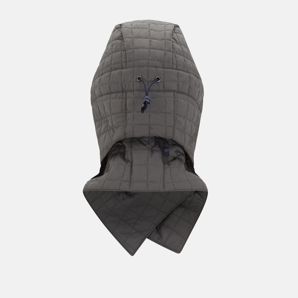 The Turnbull & Asser Shadow Grey Quilted Hood with Neck Warmer features a button closure, inspired by quilted jacket hoods, and is displayed on a plain white background.