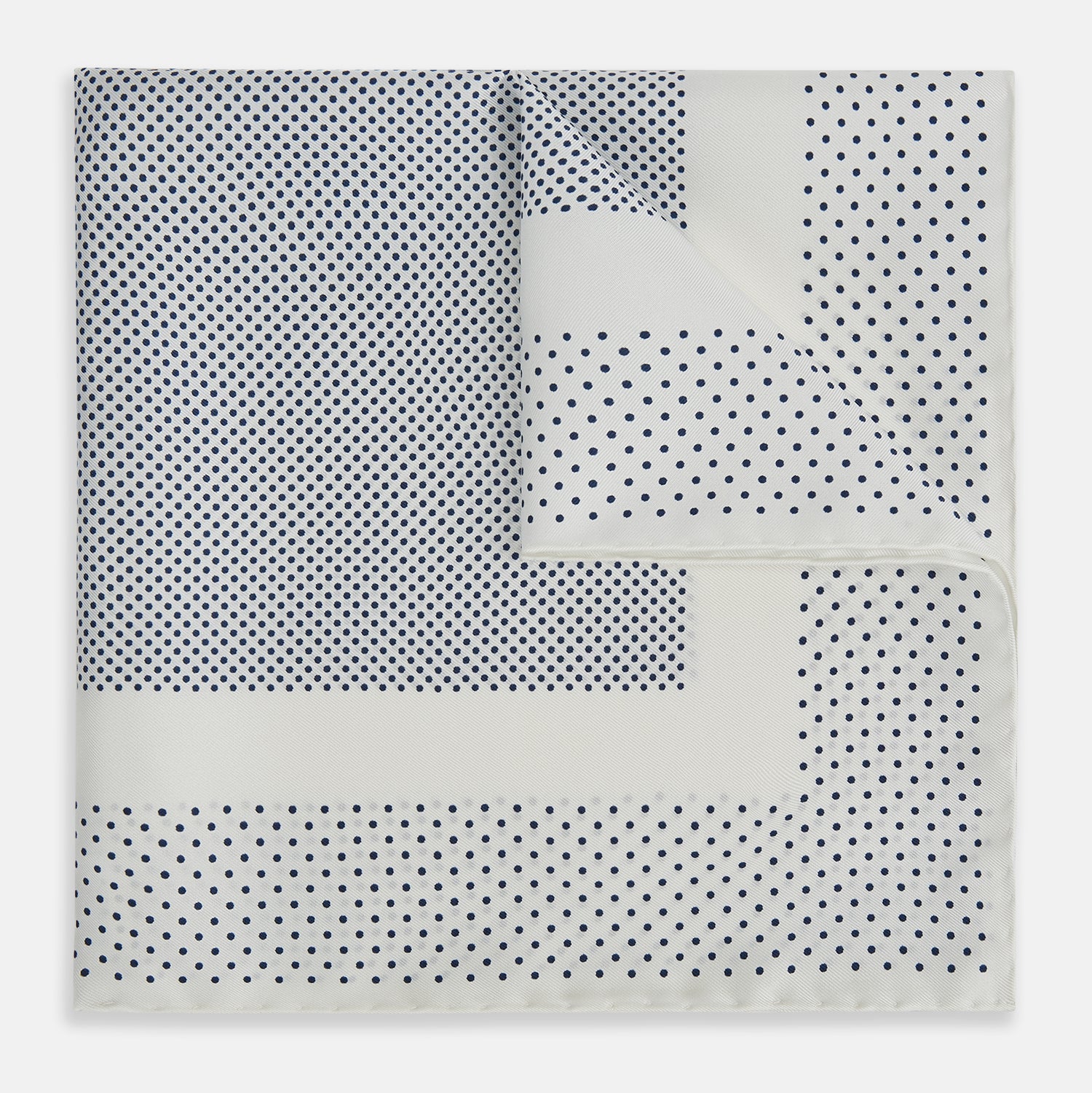 View 1 of product The Turnbull & Asser Cream Dot Silk Pocket Square features a neatly folded pure silk design with a border and center pattern of small navy blue polka dots, displayed on a plain white background.