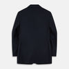 View 3 of product The Turnbull & Asser Navy Plain Wool Single Breasted Blazer, with brass front and cuff buttons and an asymmetric pocket design, is shown laid flat on a white background.