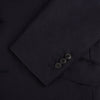 View 7 of product The Turnbull & Asser Short Navy Single Breasted Suit is shown flat on a white background, with a notch lapel jacket featuring two front pockets and matching trousers neatly folded underneath.