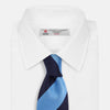 View 2 of product The BLOCK STRIPE NAVY RIVER TIE by Turnbull & Asser features bold navy and light blue diagonal stripes, rolled up neatly on a white background—a stylish essential for elevating any formal look.
