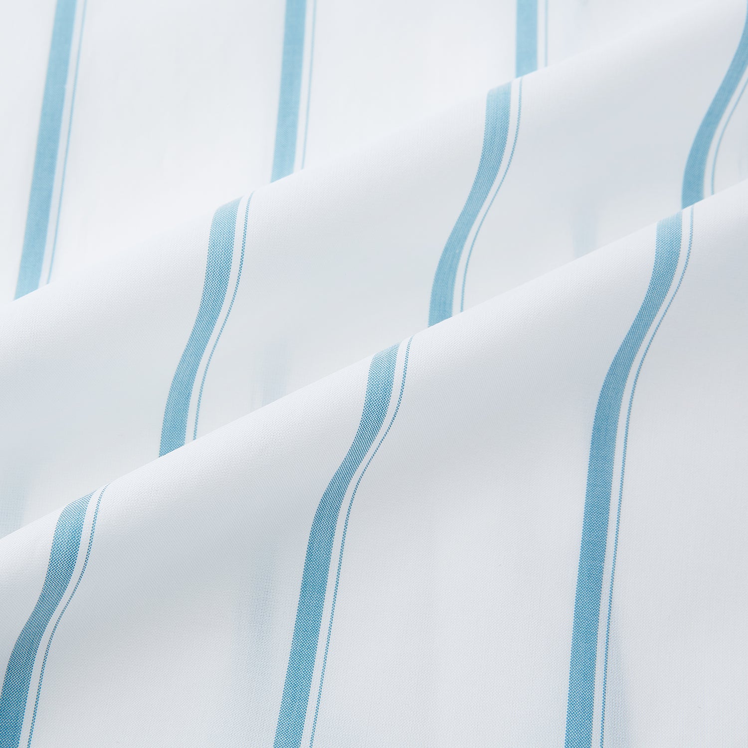 View 6 of product The Turnbull & Asser Turquoise Track Stripe Mayfair Shirt is crafted from Italian cotton with long sleeves, turquoise vertical stripes, a classic collar, and buttoned cuffs, displayed on a plain white background.