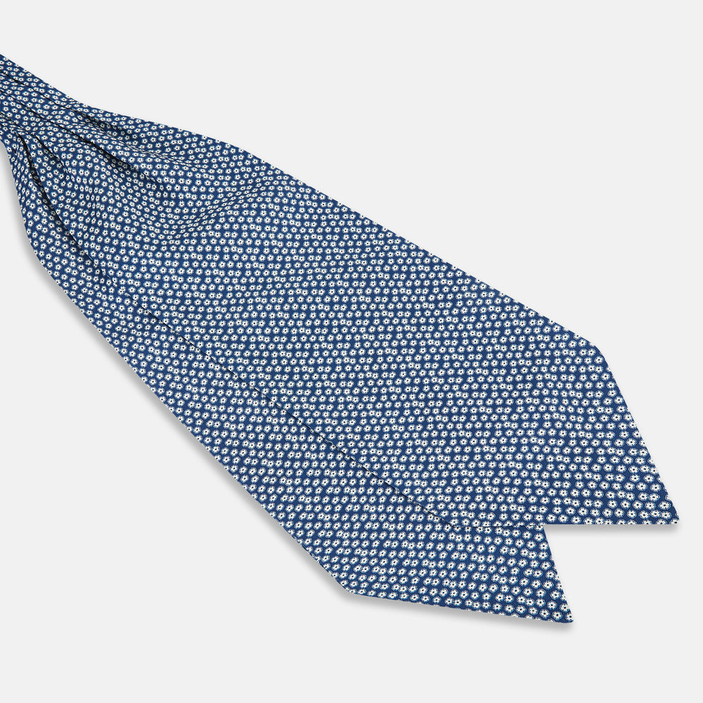 The Azzurro Flower Patterned Silk Cravat by Turnbull & Asser features a classic blue design with small white flowers—a refined British-inspired accessory.