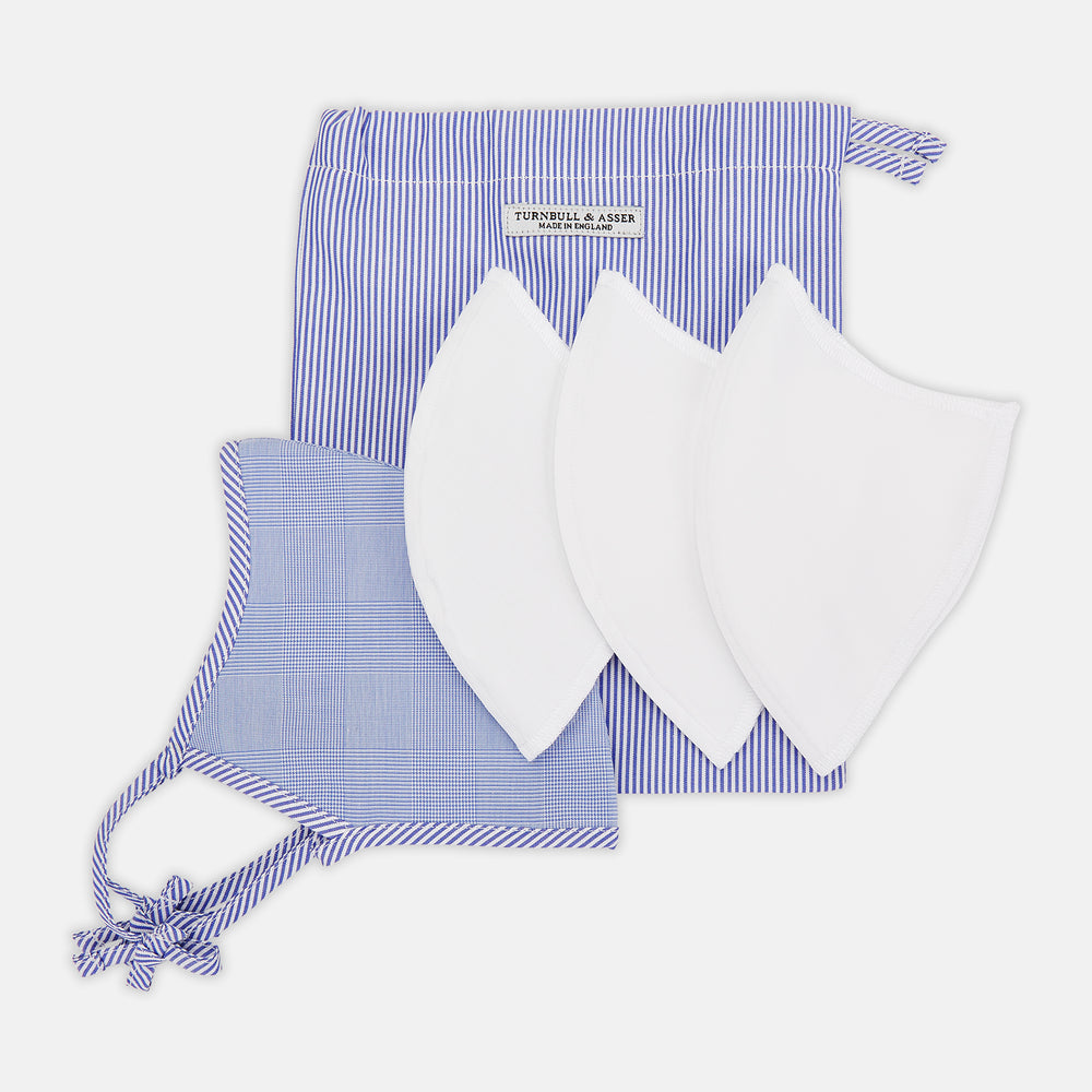 The Turnbull & Asser Blue Fine Check Zephyr Cotton Commuter Mask features a light blue and white check pattern, adjustable side ties, and comes with 3 Viroformula™ filters. Shown on a plain white background.