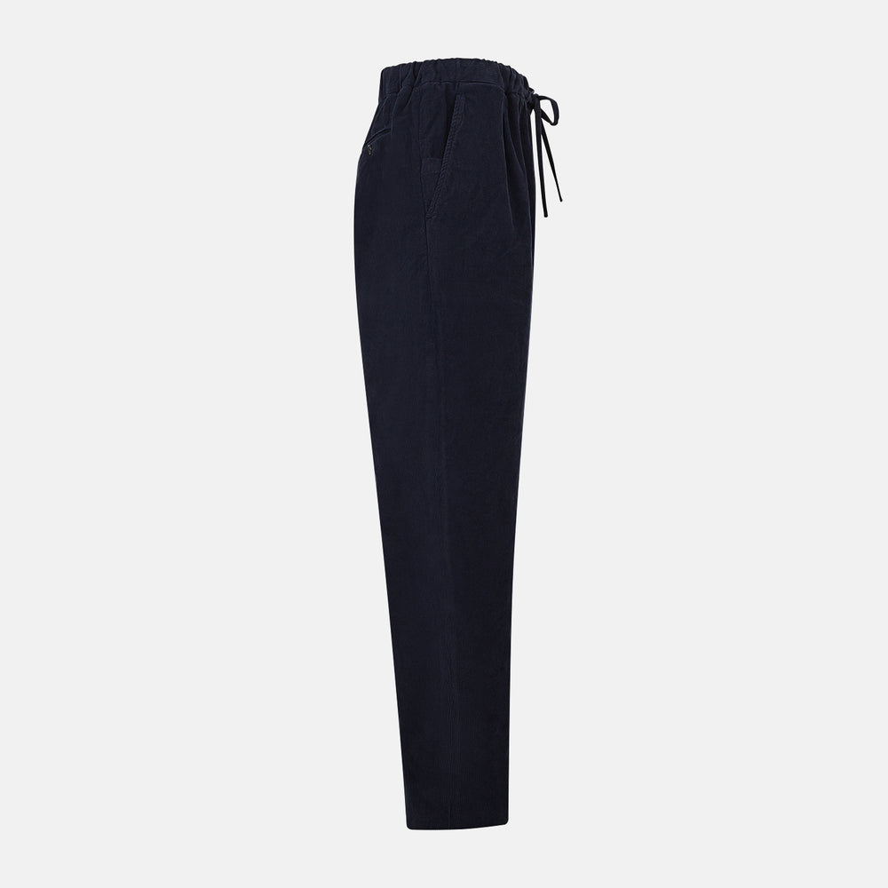 Turnbull & Asser's Light Navy Corduroy Miles Trousers feature a straight-leg stretch fit, elasticated waist, and matching fabric drawstring, shown on a plain white background.
