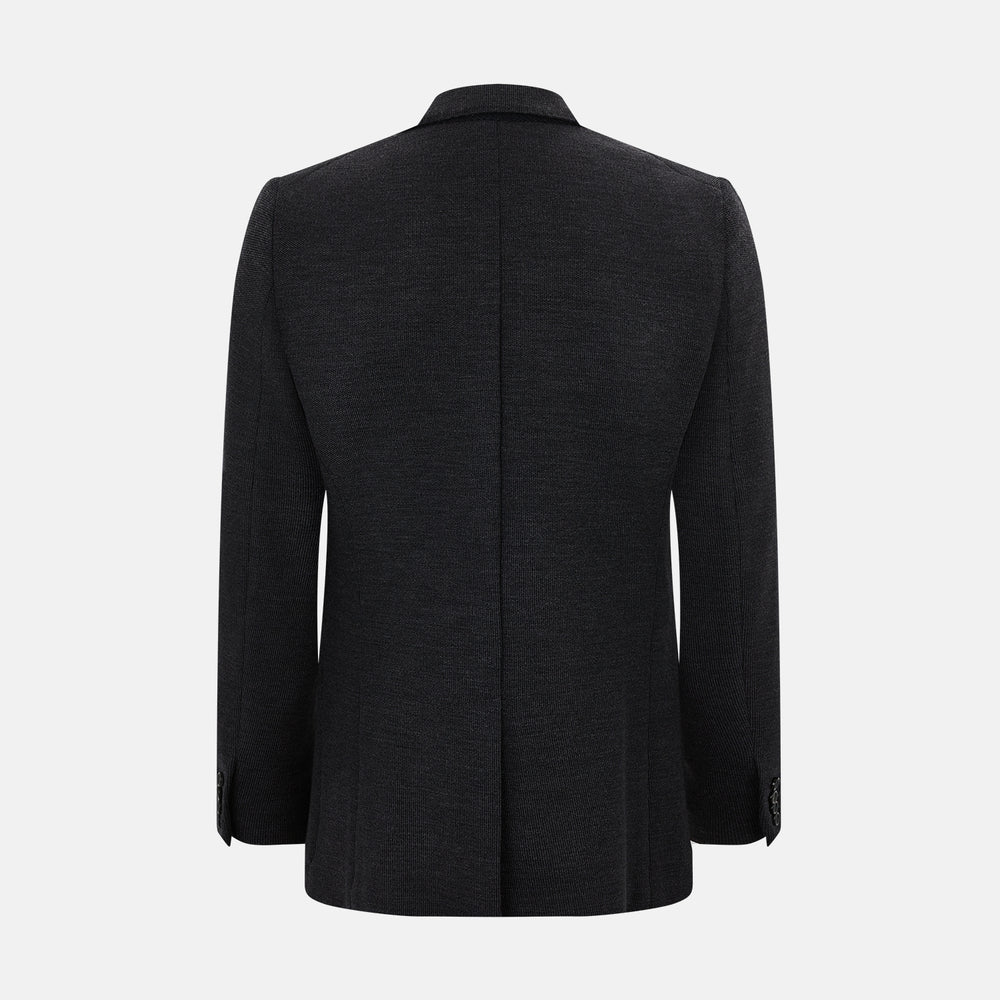 The Turnbull & Asser Charcoal Knitted Oxford Blazer features a notched lapel, two-button closure, and three front pockets, blending modern elegance with British heritage against a plain white background.