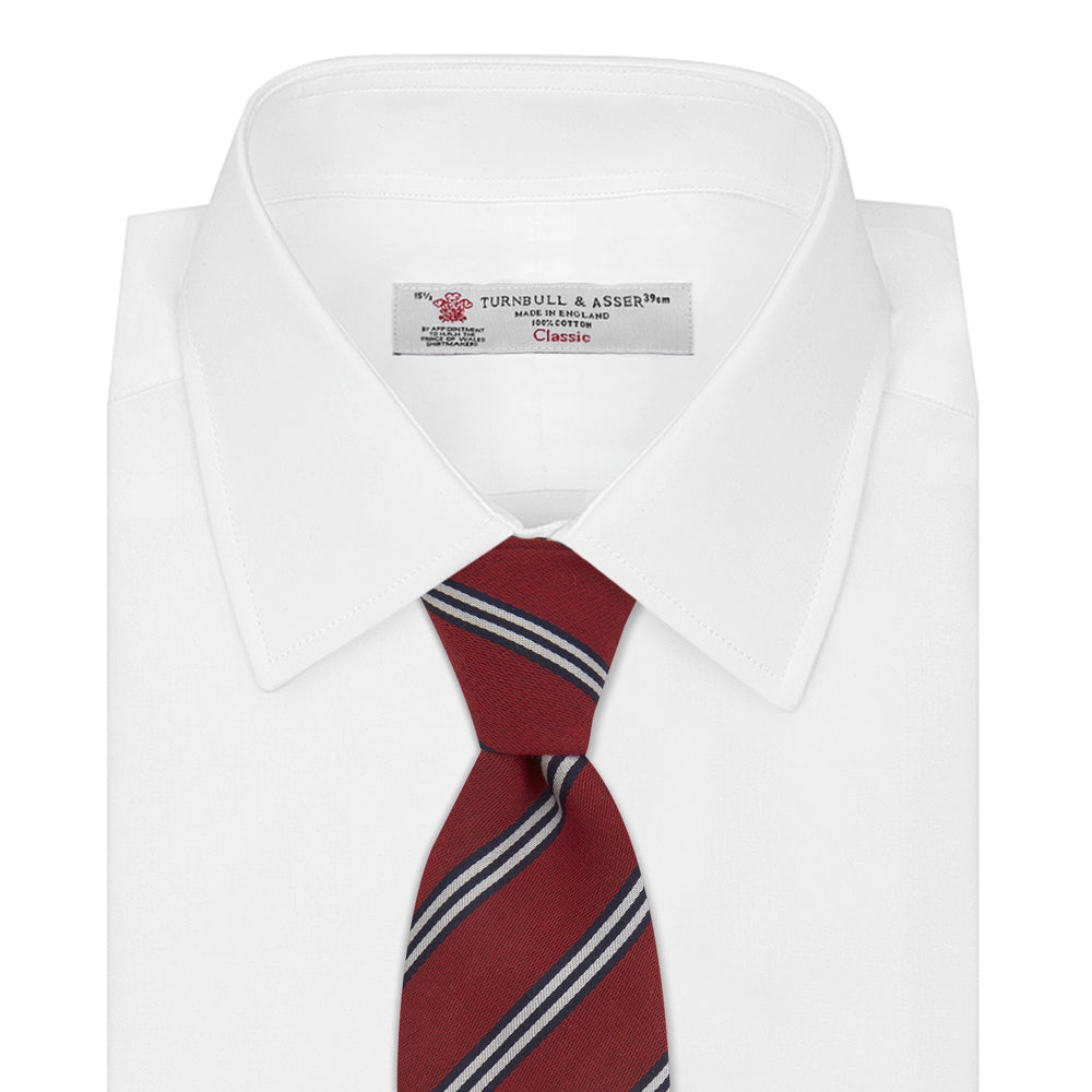 The Turnbull & Asser GGT92000 3042 48 OS is a rolled-up red cotton silk stripe tie with diagonal white and navy blue stripes, displayed on a plain white background.