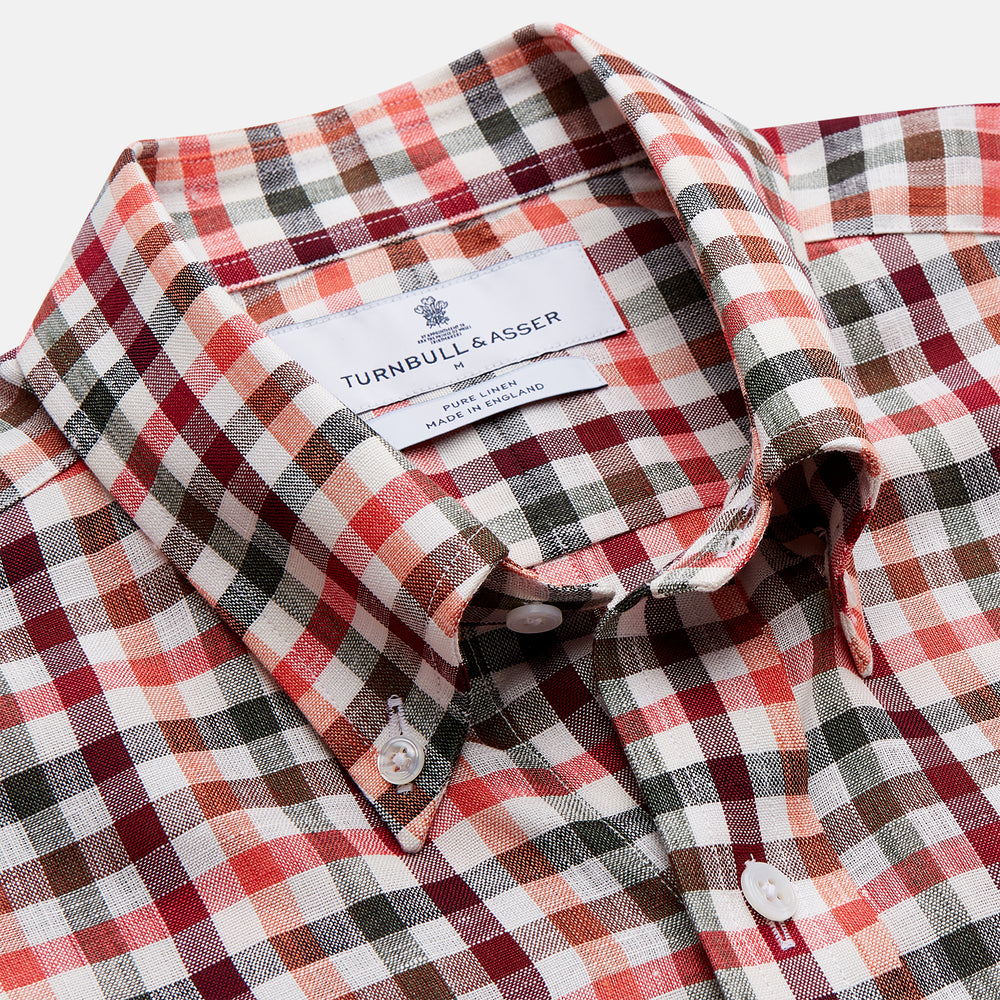 The Turnbull & Asser Red and Green Check Linen Blend Weekend Fit Hayne Shirt features a classic plaid pattern in red, white, black, and green, with a Dorset button-down collar and long sleeves. Displayed on a white background.