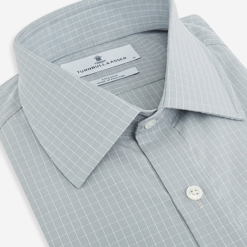 Turnbull & Asser Pale Blue Fine Check Mayfair Shirt—a long-sleeve button-up with classic collar, buttoned cuffs, white buttons, and a subtle check pattern in sanforised cotton—displayed on a white background.