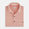 View 4 of product The Orange Polo Shirt by Turnbull & Asser features short sleeves, a collar, three-button placket, and a small buttoned chest pocket in soft cotton jersey—timeless men's style laid flat on a white background.