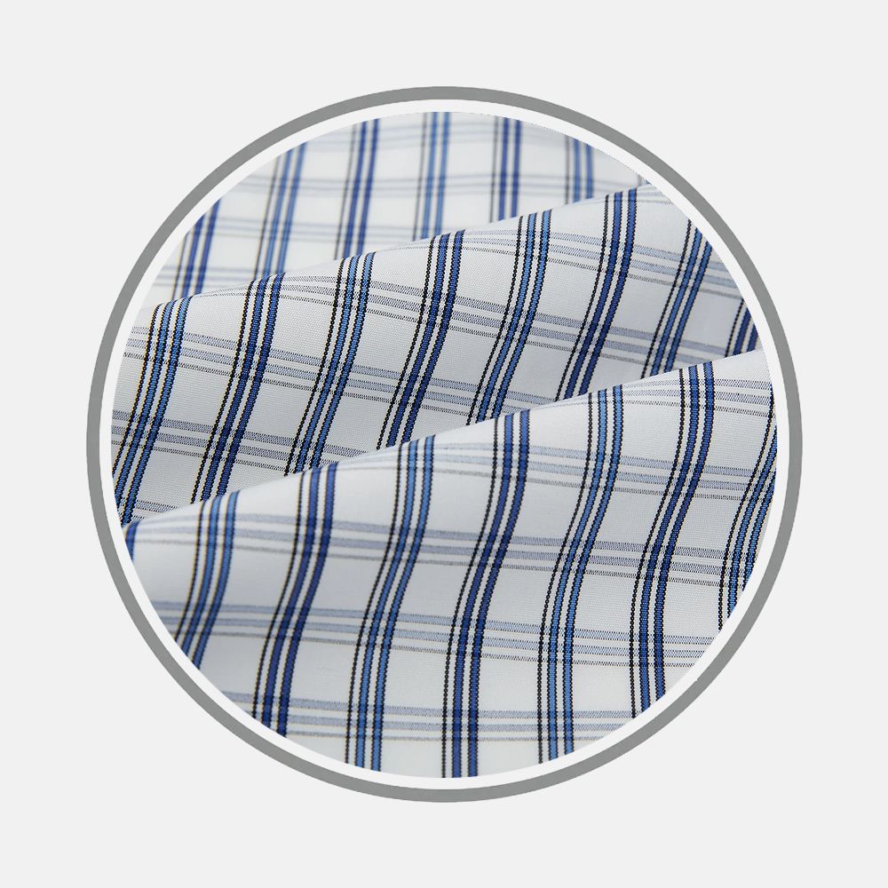 Close-up of Turnbull & Asser Navy and Blue Multi Tattersall Fabric, featuring a blue and gray plaid pattern, folded within a gray circular frame on a plain light background.