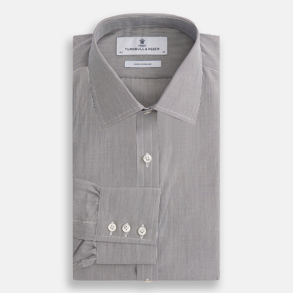 The Turnbull & Asser Navy Fine Stripe Mayfair Shirt, a long-sleeve, button-up with a classic collar, features fine navy stripes and white buttons, shown laid flat on a white background.