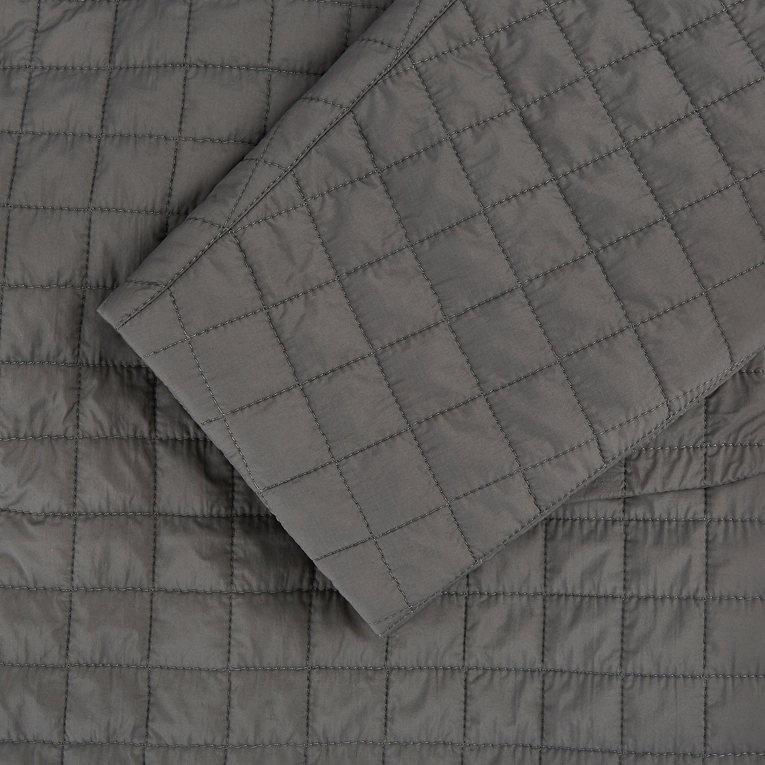Image 4 of product The Fulham Shadow Grey Single-Breasted Quilted Blazer by Turnbull & Asser features a checkered pattern, notched lapel, three front buttons, chest pocket, and two flap pockets—ideal for formal wear on a plain white background.